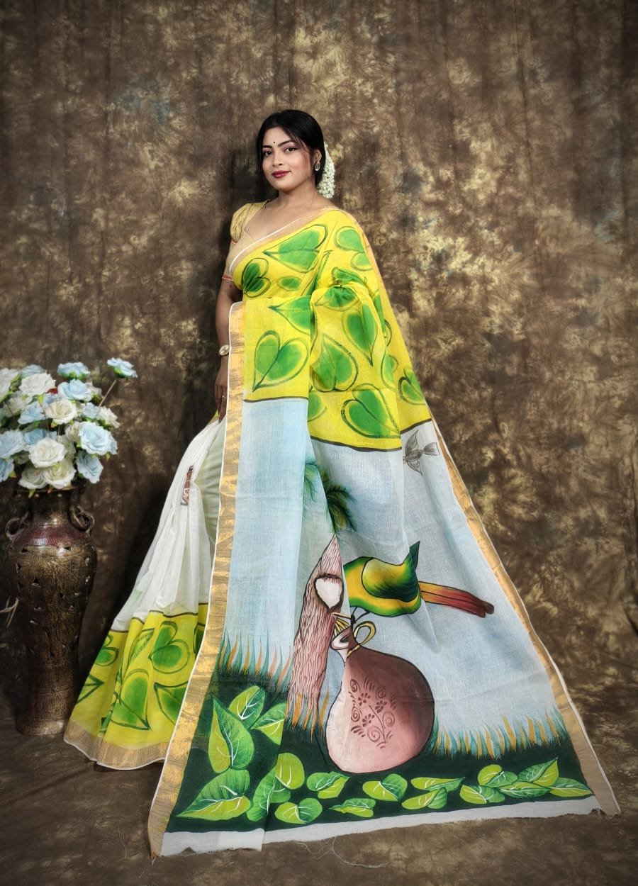 Kerala cotton hand-painted off-white saree with lime green leaf motifs and a scenic artistic pallu.