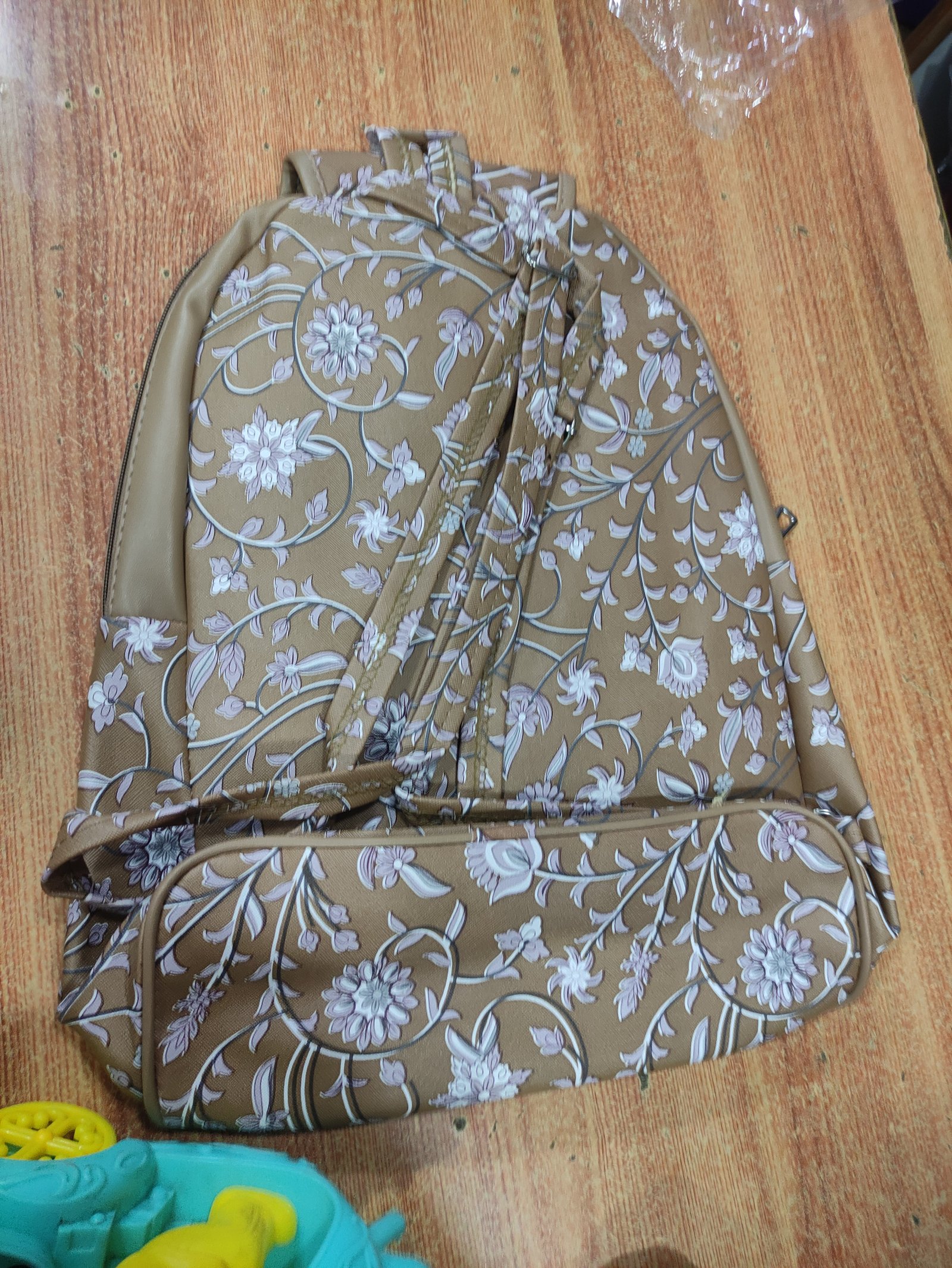 Million Bags Beige Floral Print Mini Backpack for Women & Girls | Stylish Casual Daypack with Pom-Pom Charm for Bags online India